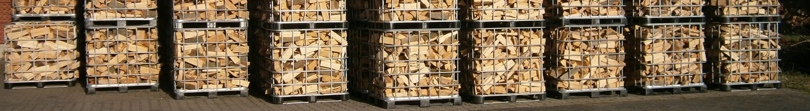 Mehrere Gitter-Container mit Holzscheiten